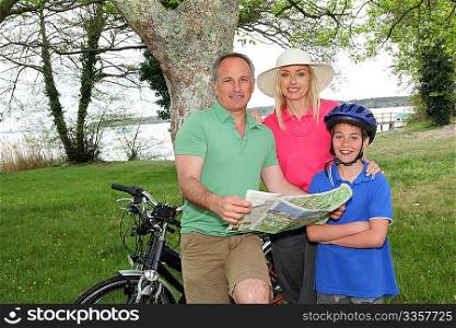 Family on bicycle ride looking at map