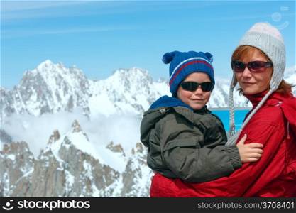 Family on observation area and Mont Blanc mountain massif behind (view from Aiguille du Midi Mount, France )