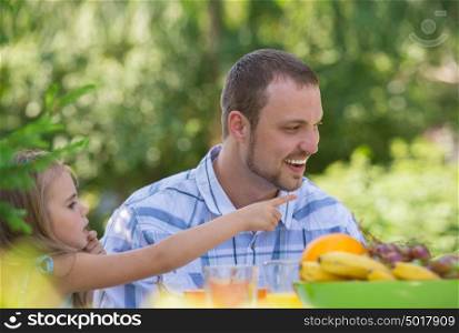 Family on picnic at summer park or backyard. Father and daughter closeup