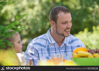 Family on picnic at summer park or backyard. Father and daughter closeup