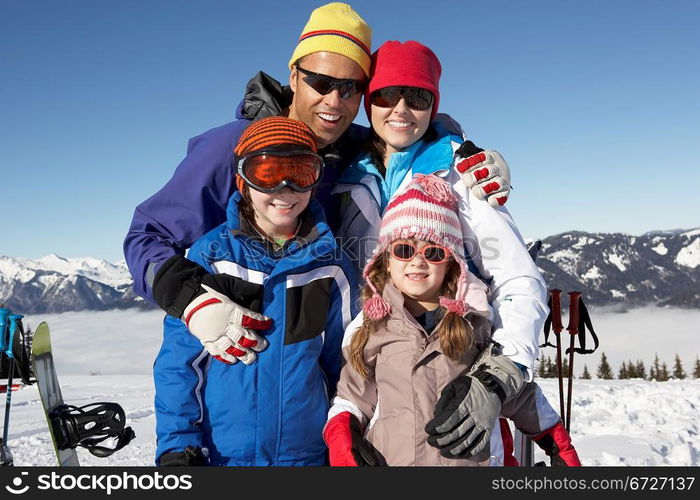 Family On Ski Holiday In Mountains