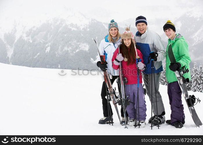 Family On Ski Holiday In Mountains