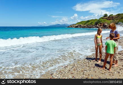 Family on summer beach (Greece, Lefkada, Ionian Sea).