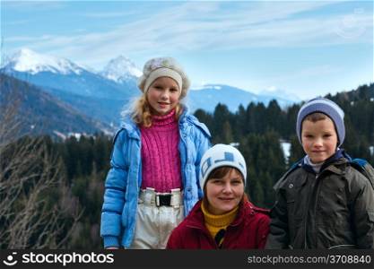 Family on winter mountain background. View from Obergail village outskirts in Lesachtal (Austria).