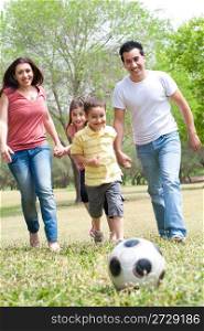 Family outdoor,playing football and having fun