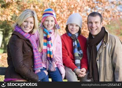 Family outdoors at park smiling (selective focus)