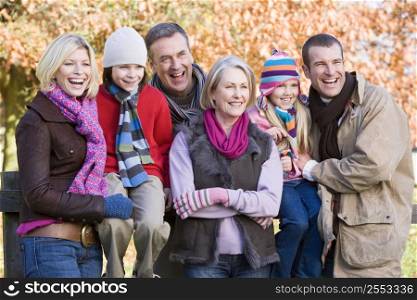 Family outdoors in park smiling (selective focus)