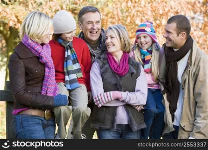 Family outdoors in park smiling (selective focus)