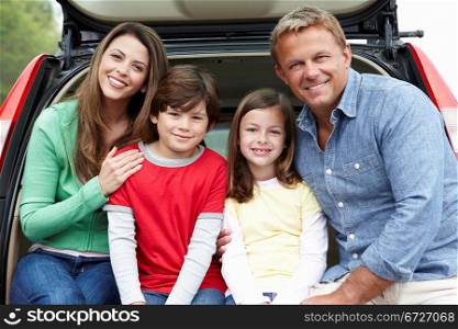 Family outdoors with car