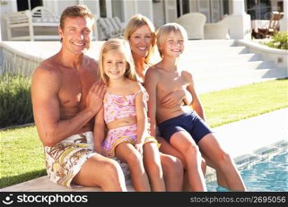 Family Outside Relaxing By Swimming Pool