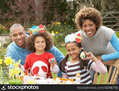 Family Painting Easter Eggs In Gardens