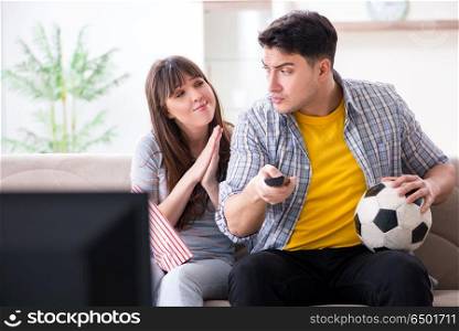 Family pair watching football at home