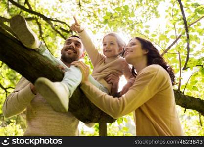 family, parenthood, adoption and people concept - happy mother, father and little girl in summer park having fun