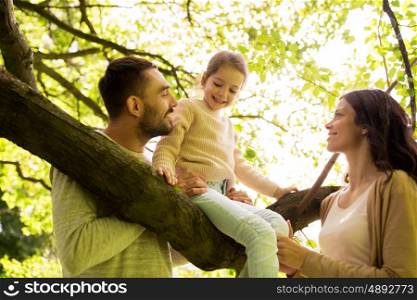 family, parenthood, adoption and people concept - happy mother, father and little girl in summer park having fun