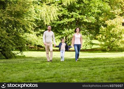 family, parenthood, adoption and people concept - happy mother, father and little girl walking in summer park. happy family walking in summer park