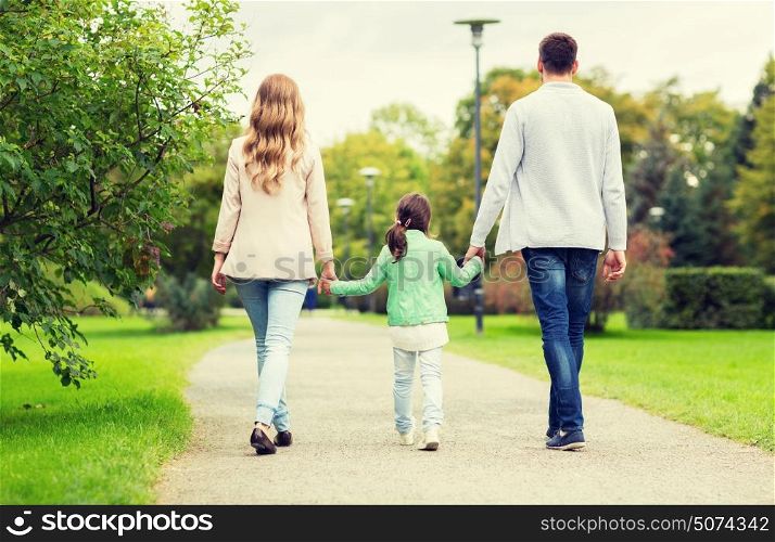 family, parenthood, adoption and people concept - happy mother, father and little girl walking in summer park. happy family walking in summer park