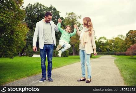 family, parenthood, adoption and people concept - happy mother, father and little girl walking in summer park and having fun. happy family walking in summer park and having fun