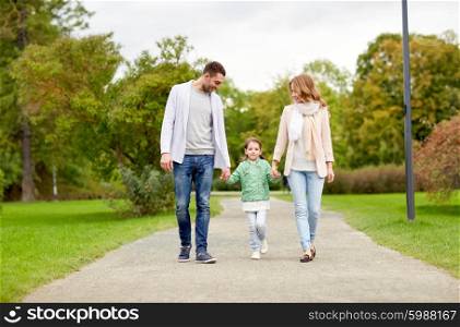 family, parenthood, adoption and people concept - happy mother, father and little girl walking in summer park