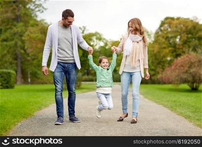 family, parenthood, adoption and people concept - happy mother, father and little girl walking in summer park and having fun