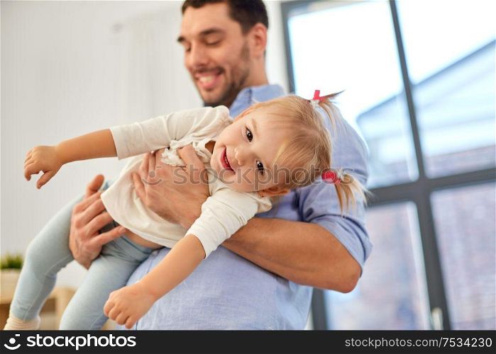 family, parenthood and fatherhood concept - father with little baby daughter at home. father with little baby daughter at home