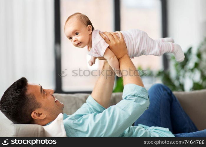 family, parenthood and fatherhood concept - happy middle aged father with little baby daughter at home. happy middle aged father with baby at home