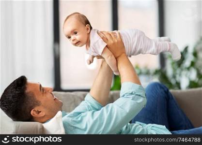 family, parenthood and fatherhood concept - happy middle aged father with little baby daughter at home. happy middle aged father with baby at home
