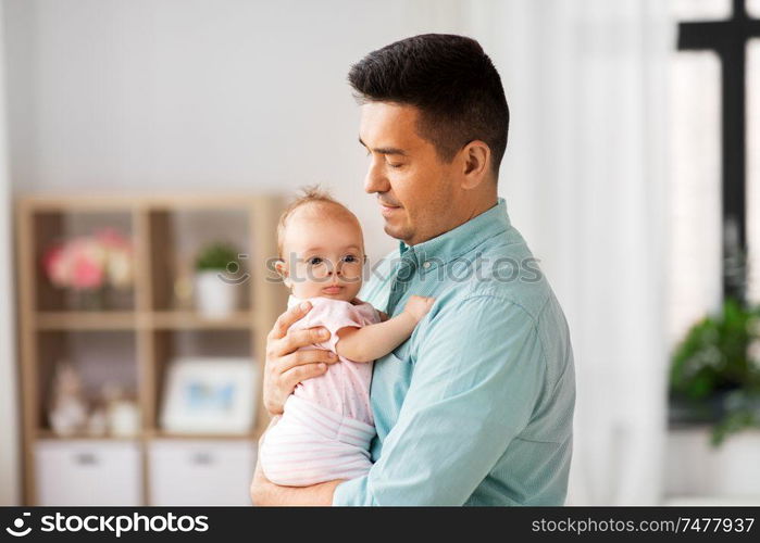 family, parenthood and fatherhood concept - middle aged father with little baby daughter at home. middle aged father with baby daughter at home