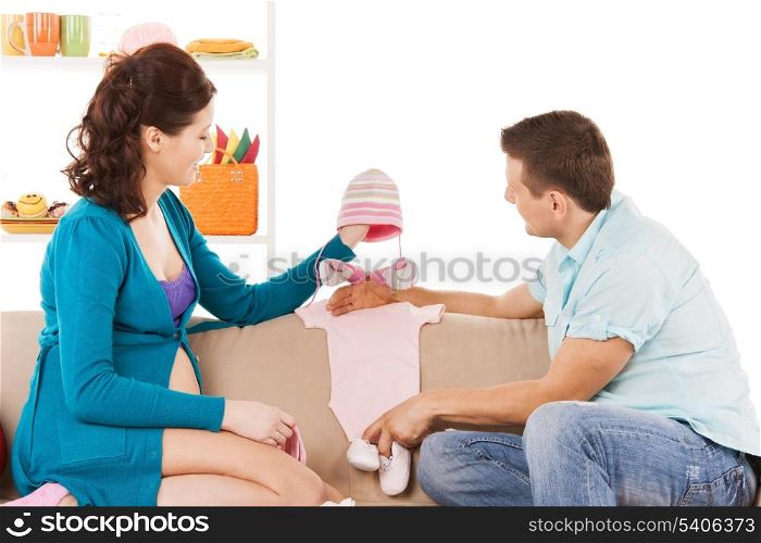 family, parenthood and happiness concept - happy expecting parents at home