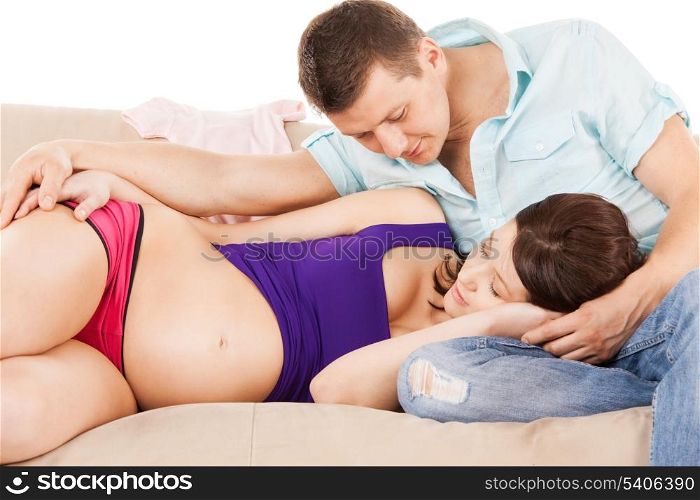 family, parenthood and happiness concept - happy expecting parents at home