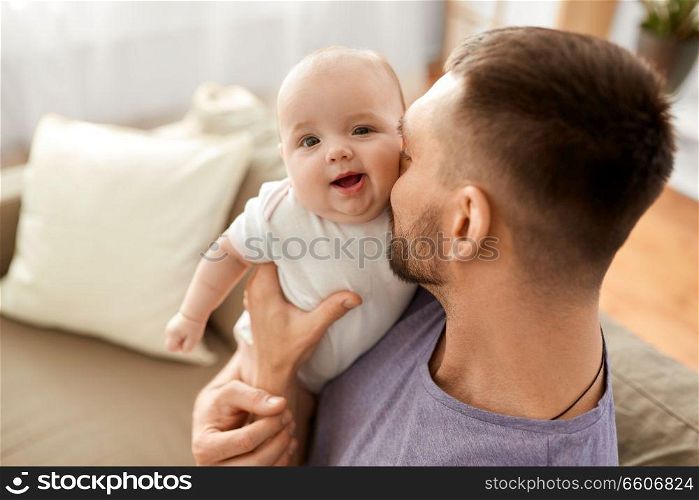 family, parenthood and people concept - close up of father with little baby girl at home. close up of father with little baby girl at home