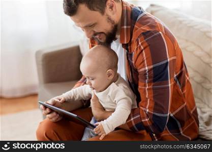 family, parenthood and people concept - close up of happy father and little baby boy with tablet pc computer at home. happy father and baby boy with tablet pc at home