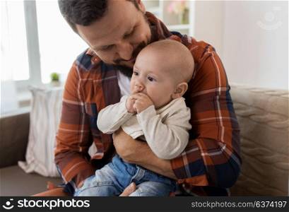 family, parenthood and people concept - close up of happy father with little baby boy at home. close up of happy father with little baby at home