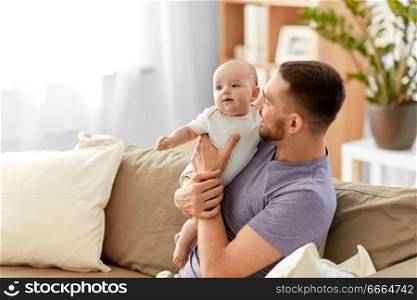 family, parenthood and people concept - father with little baby girl at home. father with little baby girl at home