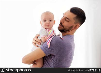 family, parenthood and people concept - father with little baby girl at home. father with little baby girl at home