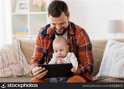 family, parenthood and people concept - happy father and little baby boy with tablet pc computer at home. happy father and baby boy with tablet pc at home