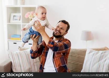 family, parenthood and people concept - happy father playing with little baby boy at home. happy father with little baby boy at home