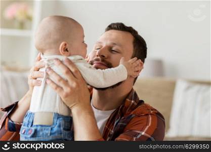 family, parenthood and people concept - happy father with little baby boy at home. close up of father with little baby boy at home