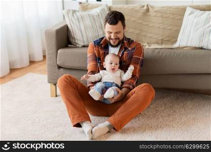 family, parenthood and people concept - happy father with little baby boy at home. happy father with little baby boy at home