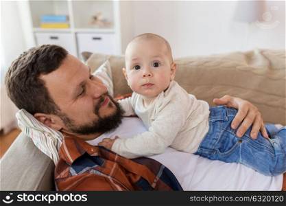 family, parenthood and people concept - happy father with little baby boy at home. happy father with little baby boy at home