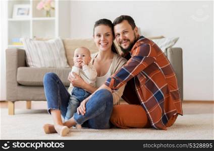 family, parenthood and people concept - happy mother, father with baby at home. happy family with baby having fun at home