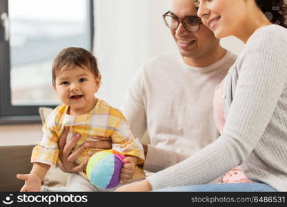 family, parenthood and people concept - happy mother, father with baby daughter at home. happy family with baby daughter at home. happy family with baby daughter at home