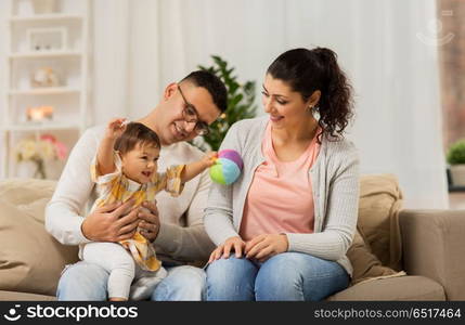 family, parenthood and people concept - happy mother, father with baby daughter at home. happy family with baby daughter at home. happy family with baby daughter at home