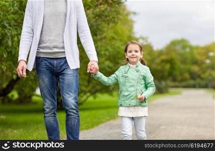 family, parenthood, fatherhood, adoption and people concept - close up of father and happy little girl walking in summer park