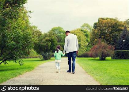 family, parenthood, fatherhood, adoption and people concept - happy father and little girl walking in summer park. happy family walking in summer park
