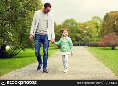 family, parenthood, fatherhood, adoption and people concept - happy father and little girl walking in summer park. happy family walking in summer park. happy family walking in summer park