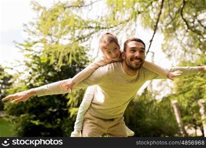 family, parenthood, fatherhood and people concept - happy man and little girl in having fun in summer park