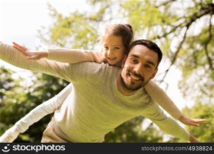 family, parenthood, fatherhood and people concept - happy man and little girl in having fun in summer park. happy family having fun in summer park