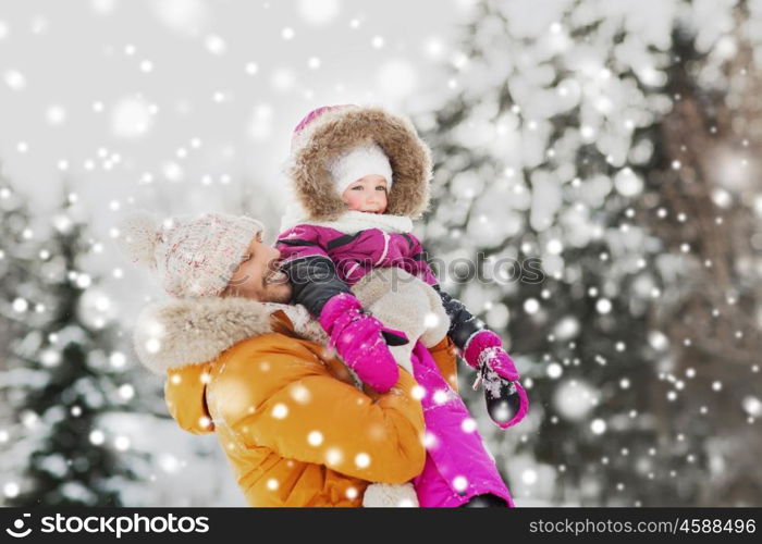 family, parenthood, fatherhood, season and people concept - happy smiling father and little girl in winter clothes outdoors