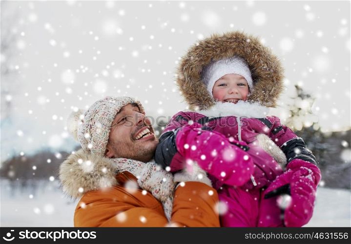 family, parenthood, fatherhood, season and people concept - happy smiling father and little girl in winter clothes outdoors