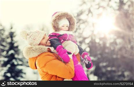 family, parenthood, fatherhood, season and people concept - happy smiling father and little girl in winter clothes outdoors. happy family in winter clothes outdoors